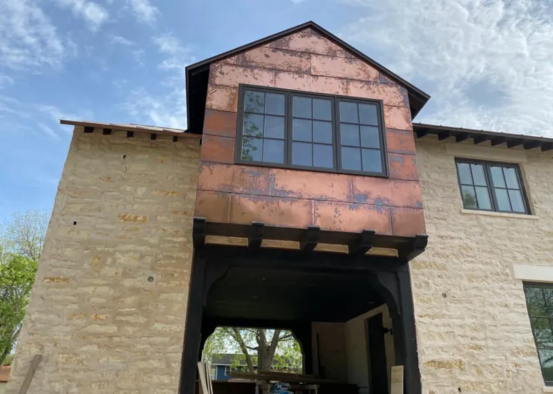 Copper metal panel facade on a stone building for Skylight Installation in Black Diamond