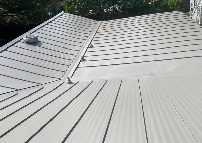 Solar attic fan installed on a metal roof for Roof Ventilation in Black Diamond